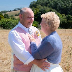 bride and groom in a field of wheat