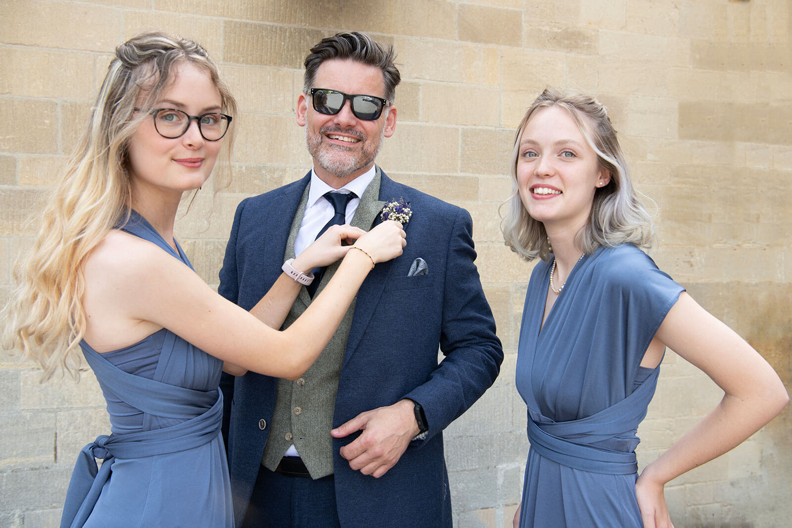 two bridesmaids and a groom