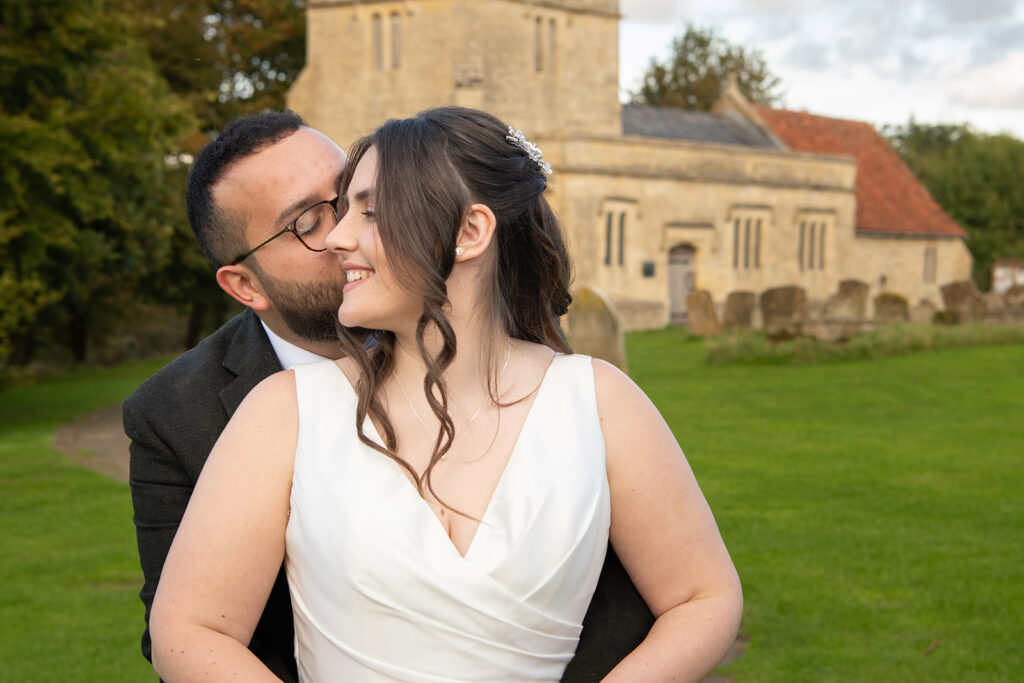 Bride and Groom in front of a classic English parish church